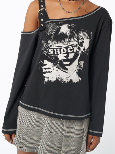 Asymmetric top in black featuring cut out shoulder with buckle grommet eyelet strap and Shocky girl graphic front print